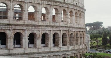 Close-up of part of the Coliseum on a sunny warm day. Italy tourist attraction, Rome. Many tourists at the foot of the monument of architecture. in 4k, red komodo photo