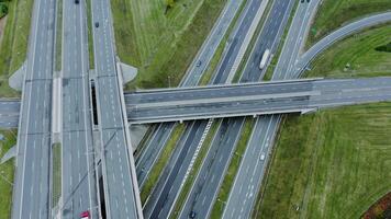 Multilevel road, top view, filming from a quadrocopter. View of the road junction with cars passing along it, shooting from a drone - passing photo