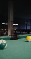 A billiard ball flies into the hole, close-up. No people in the , just a pool table, vertical - billiard photo