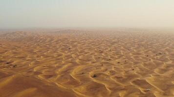Drone view of sand dunes with sand merging with the sky. Driving off-road in a lifeless desert - lifeless photo