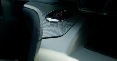 A woman presses the keyless start button of the car, close-up of her hand, an unrecognizable person - button photo
