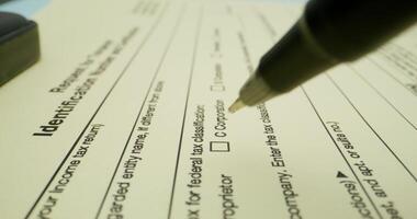 A person fills out a taxpayer's form. Close-up of a pen, an unrecognizable person - person - out photo