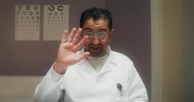 The doctor smiles and talks looking at the camera as if at a laptop screen during a online chat at the clinic photo