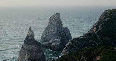 Top view of the coastline. Rocks sticking out of the water, shallow reef photo