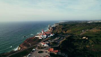 Lighthouse stands on top of a cliff on the seashore, bird's-eye view, Drone on a summer day photo