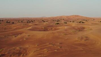 Drone view of a lifeless desert with sparse vegetation and off-road cars photo