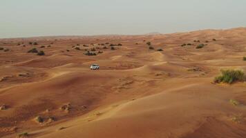 The car goes off-road on the sand dunes of the desert, drone - Scene 2 photo