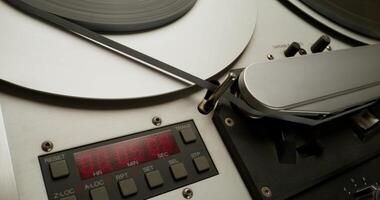 Sound recording on a tape recorder in a recording studio. Fast movement of the magnetic tape, close-up - recording - a photo