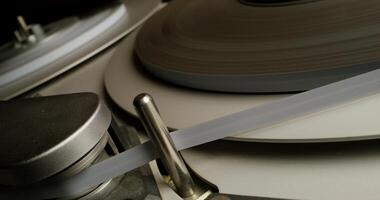 Sound recording on a tape recorder in a recording studio. Fast movement of the magnetic tape, close-up photo