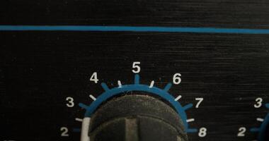 A man adjusts a vocal compressor in a recording studio. Close-up of his hand, an unrecognizable person photo