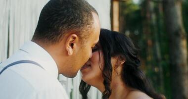 The bride and groom kiss at the wedding standing in front of the altar. Wedding in the forest - forest photo