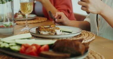 A group of young people talking and having lunch together at home during vacation photo
