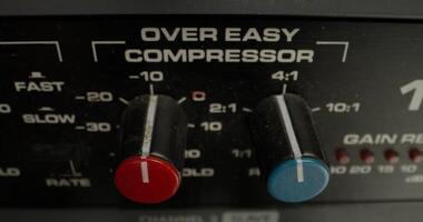A man adjusts a vocal compressor in a recording studio. Close-up of his hand, an unrecognizable person - recording photo
