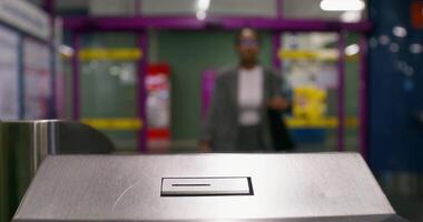 A woman inserts a ticket into a subway terminal. Close-up of her hands, an unrecognizable person photo