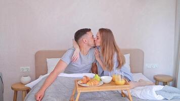 Married couple enjoying breakfast in bed in the morning at home video