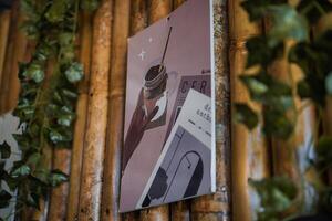 a poster hanging on the wall of a bamboo wall photo