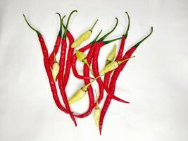 Red chilies and cayenne peppers stacked on a white background photo