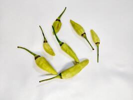 Fresh green chili is arranged on the surface of the white background photo