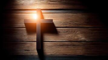 Illuminated Christian cross on wooden surface photo
