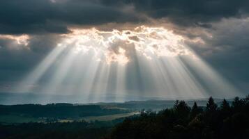 Sunlight breaking through dramatic clouds over a scenic landscape photo