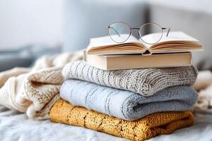 Stack of cozy books and blanket with glasses photo