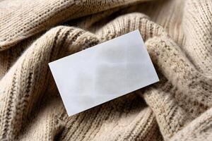Blank business card on textured fabric photo