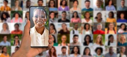 A hand holds a smartphone displaying a facial recognition scan. In the background, a collage of diverse people can be seen, highlighting modern identification technology in everyday use. photo