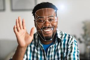 African American man with a cheerful expression participates in a facial recognition identification check. The advanced technology highlights his facial features, showcasing the new normal approach photo