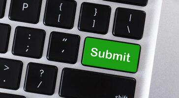 Word Submit on green button of computer keypad photo