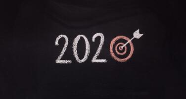 2020 goals concept. Handwriting chalk text with target instead of zero, panorama, copy space photo