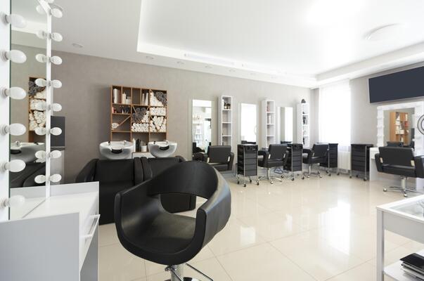 Barber chair for client on front background at interior of beauty salon