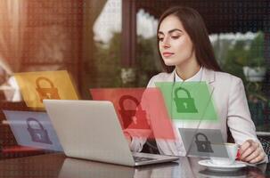 Work with blocked applications or cybersecurity. Busy business woman sitting at table in cafe, with cup of coffee and working on laptop, double exposure with abstract symbols of closed lock, collage photo