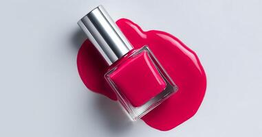 Expert nail artist applies a luxurious pink gel polish to enhance the look of manicured nails. The colorful polish is presented beside a spilled puddle, showcasing its rich texture and shine. photo