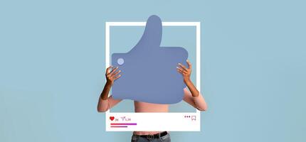 A person holds a large thumbs up symbol in front of a light blue background, symbolizing online approval. This display encourages interaction on social media platforms for content creators. photo