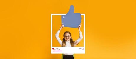 A young content creator stands with a large thumbs up symbol, expressing positivity about online engagement. The bright yellow backdrop highlights an energetic vibe, ideal for social media. photo