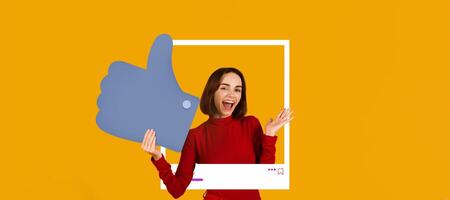A cheerful person in a red outfit expresses excitement while holding a large thumbs-up symbol against a vibrant orange background. The setting represents the world of online content creation. photo