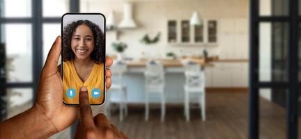 A person using their smartphone to participate in a virtual chat at home. The setting features a modern kitchen with a warm atmosphere, enhancing the online communication experience. photo
