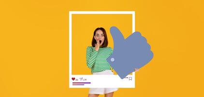 A young influencer expresses surprise and delight while holding a large thumbs up symbol in front of a vibrant yellow background. She showcases enthusiasm for engaging content online. photo