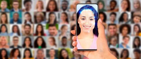 A person uses a smartphone to scan a face for recognition among a collage of portraits. This modern technology showcases advancements in identification methods. photo