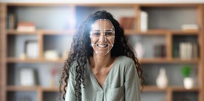 Facial recognition technology is utilized for identification, showcasing a woman with curly hair smiling while a digital overlay displays facial features. photo