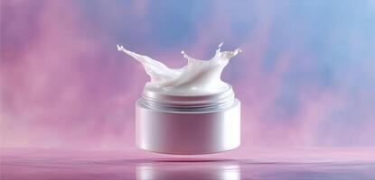 A jar of cream hovers above a reflective surface, capturing a drop that splashes upwards. The vibrant gradient background transitions from soft pinks to blues, enhancing the focus on the product. photo