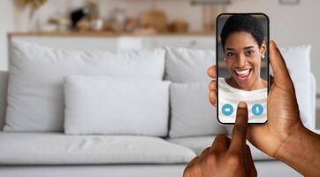 A person engages in an online call with friend, using a smartphone, smiling as they talk. Comfortable home surroundings enhance the connection in this virtual communication. photo