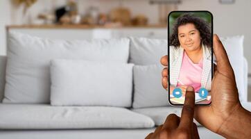 A person is holding a smartphone displaying a call with a friend. The cozy home setting features a comfortable couch, emphasizing casual communication and connection. photo