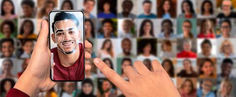 A person holds a smartphone displaying face recognition technology. The device showcases a smiling face with a digital overlay, surrounded by a collage of diverse faces in the background. photo