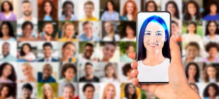 A person holds a smartphone displaying a scanned face with various portraits in the background. This showcases advancements in identification technology in a bustling, modern setting. photo