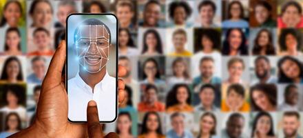 A person holds a smartphone screen displaying a facial recognition scan while surrounded by a collage of diverse faces. photo