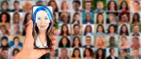 A hand holds a smartphone displaying a face scanning feature, while a collage of diverse faces fills the background. This showcases modern identification technology in action. photo