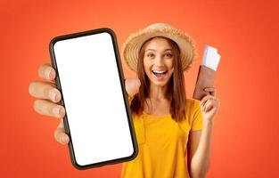 Emotional female traveller with passport and tickets in her hand showing thumb up, yellow studio background photo