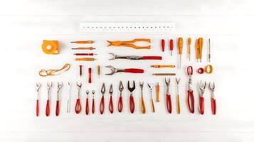 A neatly arranged collection of various hand tools on a white wooden surface for DIY projects photo