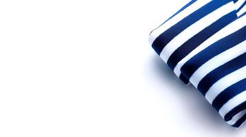 A neatly folded navy and white striped fabric resting on a clean, bright surface, showcasing its texture photo